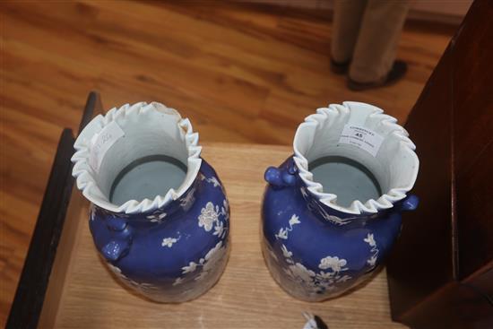 A pair of 19th century Chinese blue ground vases, with white floral decoration